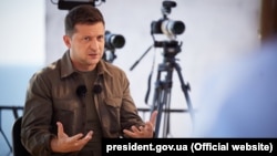 Ukrainian President Volodymyr Zelenskiy talks to Ukrainian journalists at a press event on Zmiyiniy Island in the Black Sea on August 19. 