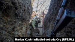 A Ukrainian soldier digs a trench near Horlivka in the Donetsk region.