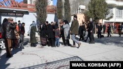 Relatives of the victims arrive at the site where gunmen shot dead two Afghan female judges working for the Supreme Court in Kabul on January 17.