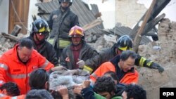 Рятувальні команди дістають людини з будівлі, що звалилася в результаті землетрусу, м. Л'Акуіла, 7 квітня 2009 р.